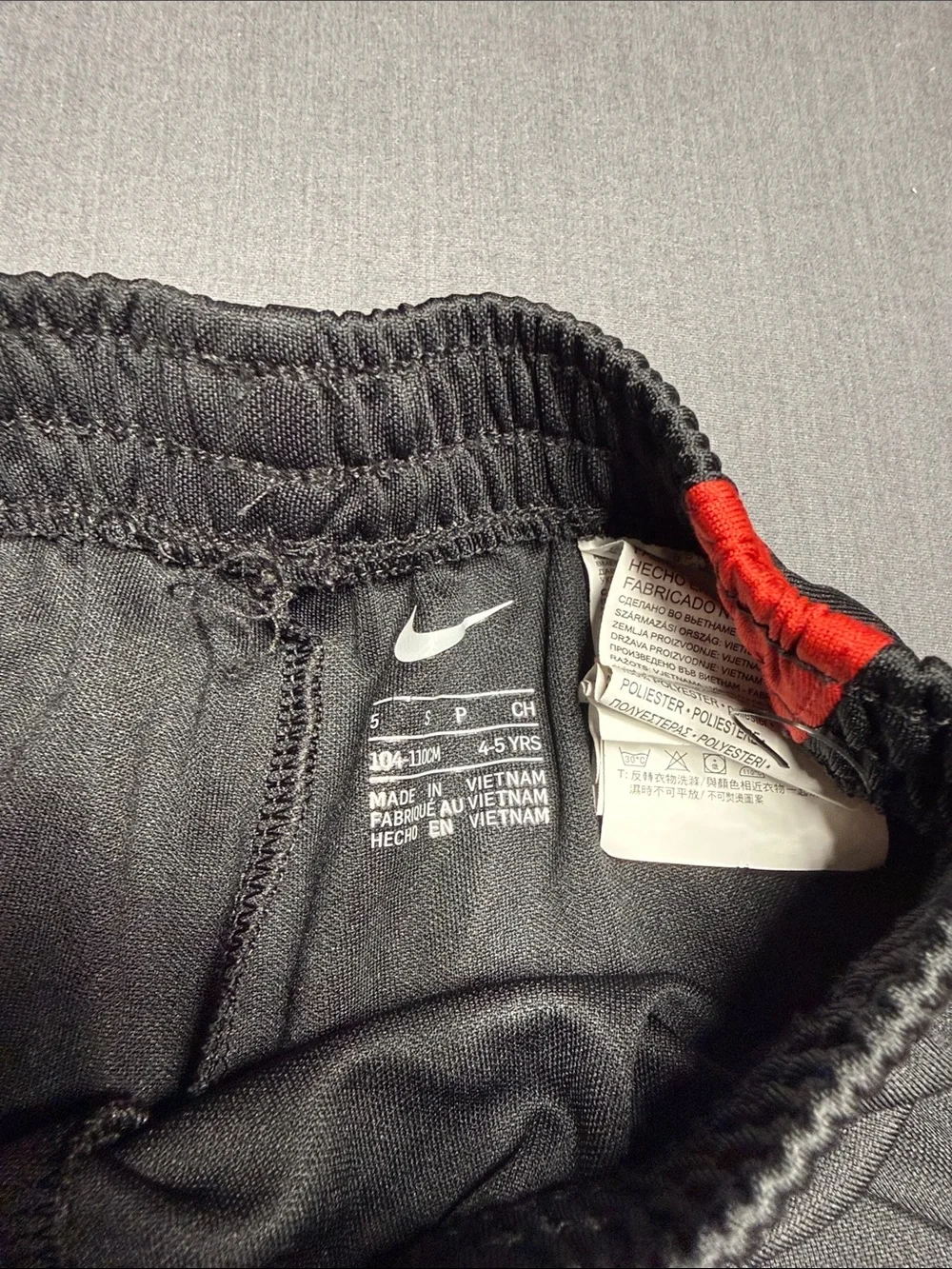 Nike Black Kids Shorts with Red Accent and White Swoosh